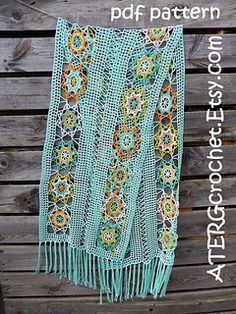 a crocheted shawl hanging on a wooden fence with text overlay that reads, free pattern