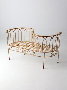 an old metal bed frame sitting on top of a white floor