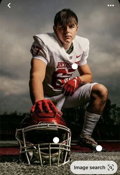 a football player kneeling down with his helmet on