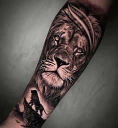 a man's arm with a lion tattoo on it, and an animal in the middle