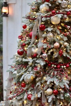 a decorated christmas tree with red, white and gold ornaments