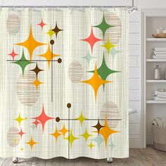 the shower curtain is decorated with colorful stars and circles on white walls, along with a wooden floor