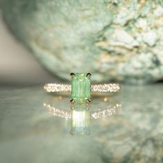 Give your style a sparkle with our Classic Prong Hidden Halo Sapphire solitaire with French Set diamond band. A 1.67ct emerald cut, opalescent green sapphire is at its center, measuring around 8x5mm. Its unique profile elevates your style and makes it easy to mix and match with similar bands. Crafted from recycled 18k yellow gold and decorated with delicate tapered, natural diamonds from 1.3mm to 2mm in size, this beauty will make a statement. Finish off your look with either a classic polished Luxury Emerald Cut Ring With Gemstone Accents, Luxury Radiant Cut May Birthstone Jewelry, Green Moissanite Jewelry In Radiant Cut, Green Moissanite Radiant Cut Jewelry, Green Moissanite Jewelry With Radiant Cut, Green Radiant Cut Moissanite Jewelry, Emerald Cut Green Gemstones With Accent Stones, Green Jewelry With Radiant Cut Accent Stones, Green Asscher Cut Moissanite Jewelry