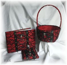 two red purses sitting next to each other on a white sheet