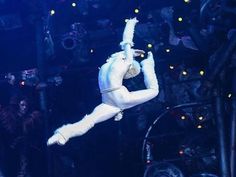 a man dressed as santa claus hanging upside down in the air