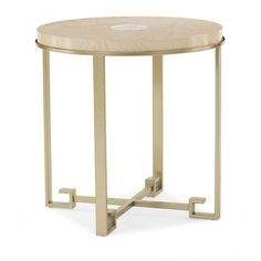 a small round table with metal legs and a beige cushion on the top, against a white background