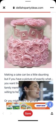 a pink cake with roses on it and the words baby spelled out