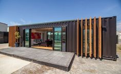 a house made out of shipping containers with sliding doors