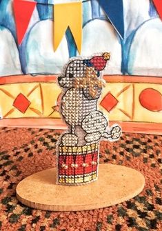 an elephant is standing on top of a cupcake in front of a circus backdrop