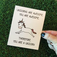 someone holding up a card that says unicorns are awesome you are awesome, there is a unicorn on it