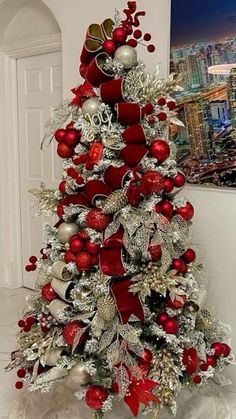 a red and silver christmas tree decorated with ornaments