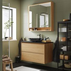 a bathroom with a sink, mirror and shelves