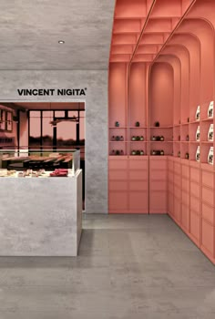 a store with pink walls and shelves filled with items in it's display area