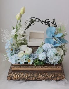 an arrangement of flowers in a wooden box