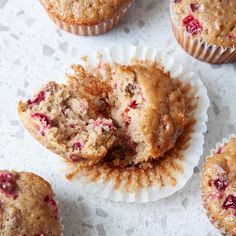 muffins with cranberry filling sitting on a table