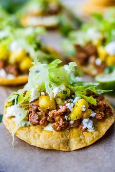 some taco shells with lettuce and other toppings on top of them