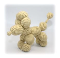 a crocheted stuffed animal sitting on top of a white surface