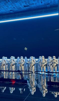 a group of star wars characters are reflected in the water