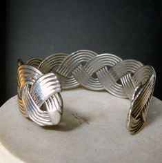 "Woven Silver Cuff Bracelet, Geometric Stylized Dynamic Metal Jewelry 1980s Woven silvertone metal cuff is 6\" long by 1\" wide ( 15.24cm x 2.54cm ) The Cuff opening is 1\" ( 26mmm ) this bracelet looks like old sterling silver , can high polish but is just metal Woven nautical rope style -------------------------------------------------------------------- PLEASE NOTE I ONLY ship to your paid ETSY invoiced address International Shipping rates have gone up, why not combine several pieces in one o Nautical Rope, Beaded Dangle Earrings, Resin Beads, Silver Cuff Bracelet, Tube Beads, Small Jewelry, Beaded Dangles, Silver Cuff, Metal Jewelry