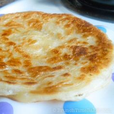 some food is sitting on a plate with blue and white polka dot paper around it