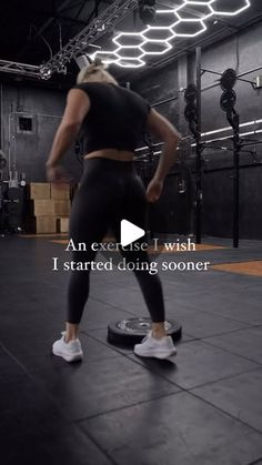 a woman standing on top of a skateboard in a room with an exercise i wish sign above her