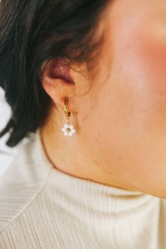 Spruce up your outfit with these playful Dropping Daisies Earrings! These gold hoops feature a charming white beaded flower design with a gold center, adding a touch of whimsy to your look. Perfect for adding a fun and unique twist to any outfit. Gold earrings White beaded flower design with gold center Huggie/hoop earrings with dropped flowers Beaded Huggie Earrings, Dainty White Dangle Flower Earrings, Cute Gold Flower Charm Earrings, Trendy White Hoop Earrings With Pearl Drop, Spring Pearl Drop Gold Earrings, Gold Pearl Drop Earrings For Spring, Spring Gold Pearl Drop Earrings, White Small Hoop Pearl Earrings Single Earring, Delicate Small Hoop White Earrings