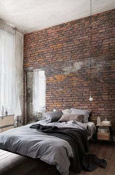 a bedroom with brick walls and a large bed