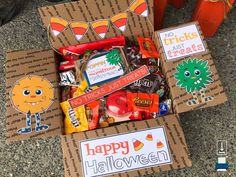 a box filled with halloween candy sitting on top of a table next to other boxes