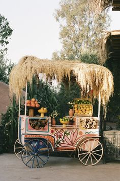 an old fashioned fruit cart with straw roof