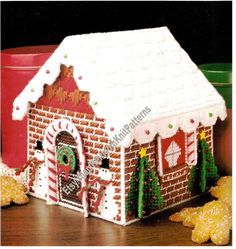 a gingerbread house is decorated with icing and candy canes for the holiday season