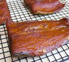 three pieces of meat sitting on top of a cooling rack