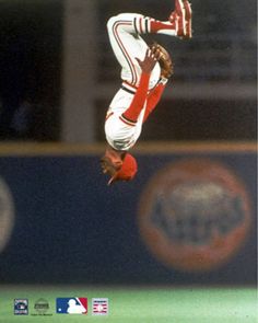 a baseball player in mid air after hitting the ball