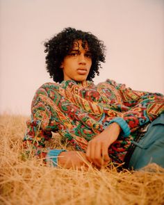 a woman sitting in the middle of a field