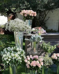 several vases filled with flowers sitting on top of a table