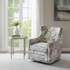 a living room scene with focus on the chair and side table in front of the window