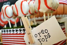 some lollipops are sitting on sticks with a sign that says oreo pops