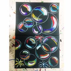 two pieces of art that have been drawn on black paper with colored circles and stars