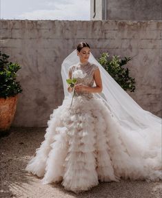 a woman in a wedding dress holding a flower