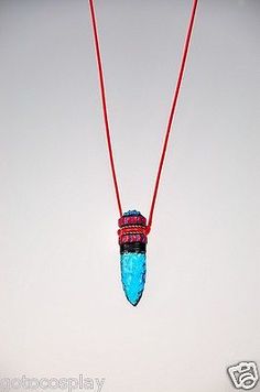 a red string with a blue bead hanging from it's end is attached to a necklace