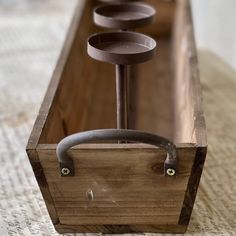 a wooden box with four candles in it