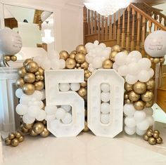 a large number sign made out of balloons in front of a staircase with stairs and balconies