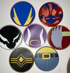 six circular stickers with different designs on them, all in various shapes and sizes