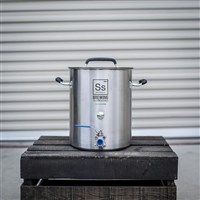 a stainless steel pot sitting on top of a wooden crate