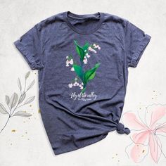 a t - shirt that says lily of the valley on it with flowers around it