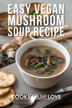 easy vegan mushroom soup recipe in a white bowl with crackers on the side