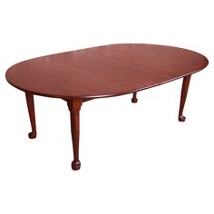 an oval wooden table with four legs