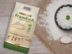 rice in a bag next to a bowl and spoon on a wooden table with white rice