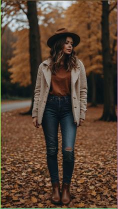 Embrace the cozy vibes of autumn with this chic fall outfit casual look. Featuring a stylish wide-brim hat, a toasty beige cardigan, a warm brown top, paired with distressed skinny jeans and classic brown ankle boots, this outfit effortlessly combines comfort and fashion. Perfect for those crisp fall days, this ensemble will keep you looking stylish and feeling warm. Visit our site for more inspiration and to shop the look. Upgrade your autumn wardrobe with stunning casual fall outfits today!#FallOutfit #CasualLook #AutumnStyle #FashionInspo #FallFashion #OutfitIdeas #CozyVibes Fall Fedora Hat Outfit, Fedora Hat Outfits, Fall Outfits With Hats, Fall Outfit Casual, Chic Fall Outfit, Glamorous Evening Dresses, Boots Outfit Ankle, 2024 Outfits