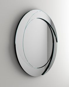 a round mirror on the wall with curved edges