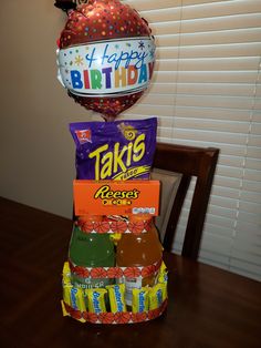 a birthday cake made to look like it is stacked on top of each other with balloons and confetti